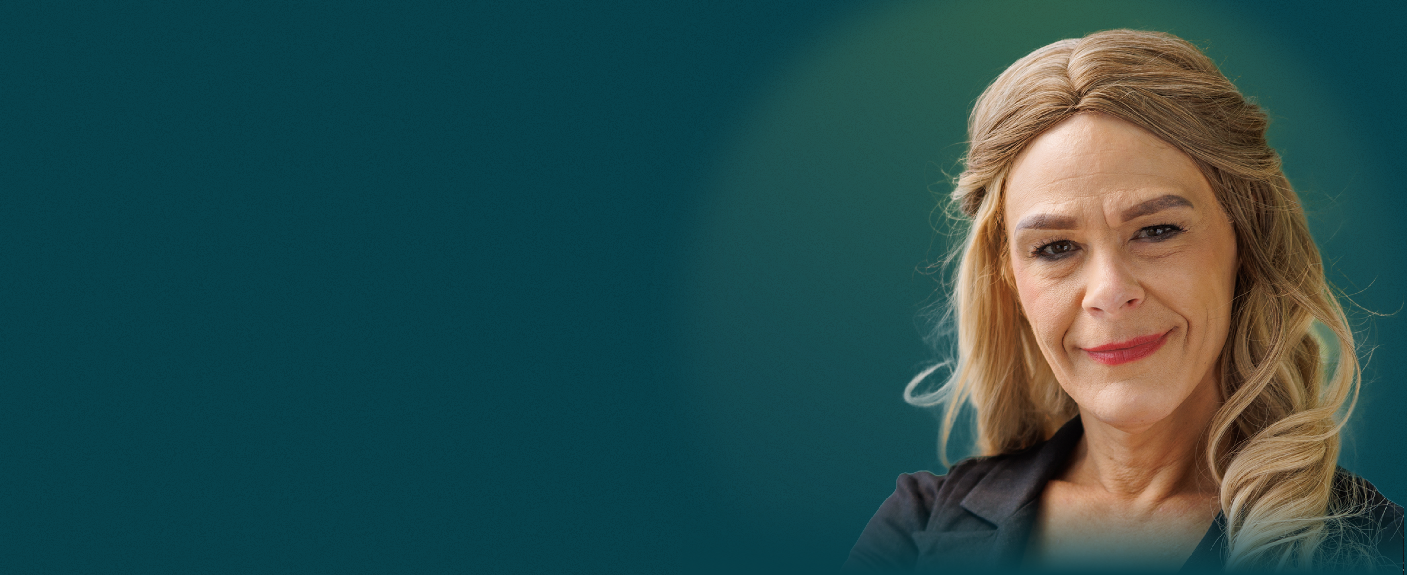 A white woman with long blonde hair faces the camera with a neutral smile