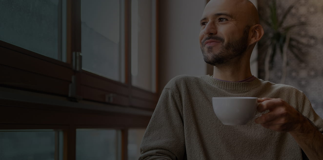 Actor portrayal of a man looking out a window.