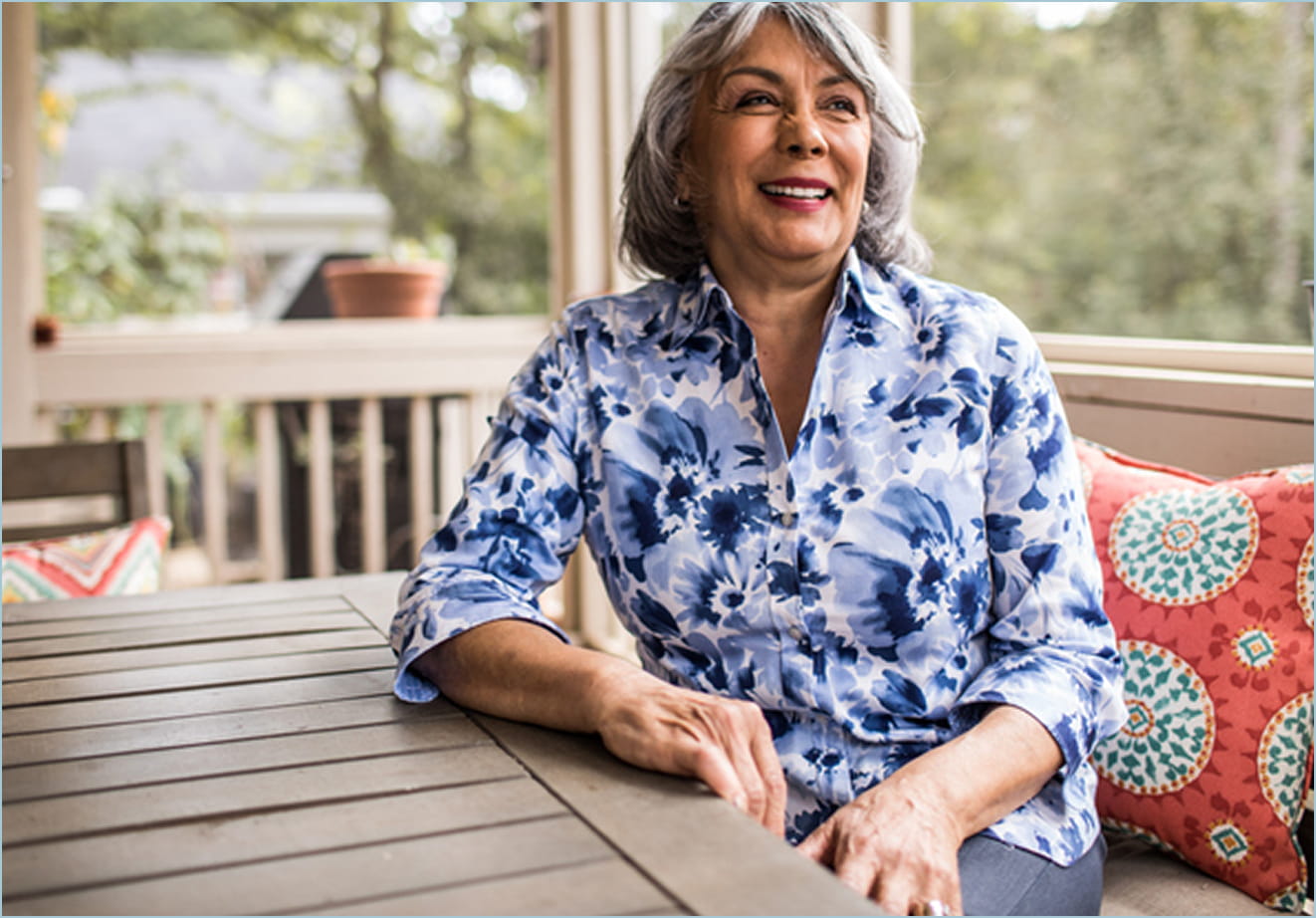 A smiling African American woman seen from the waist up.