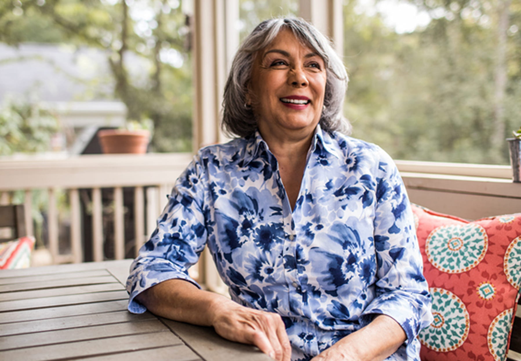 A smiling African American woman seen from the waist up.