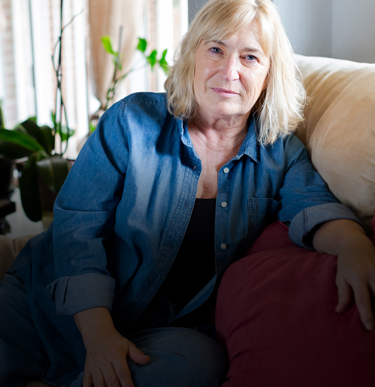 A senior woman sitting on her couch.