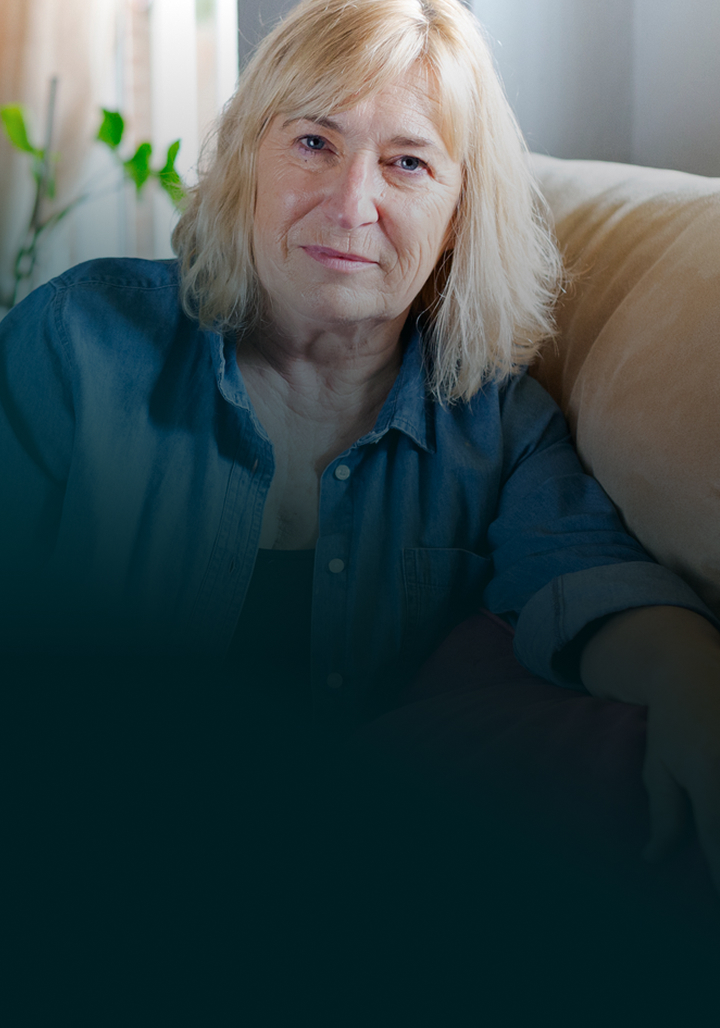A senior woman sitting on her couch.