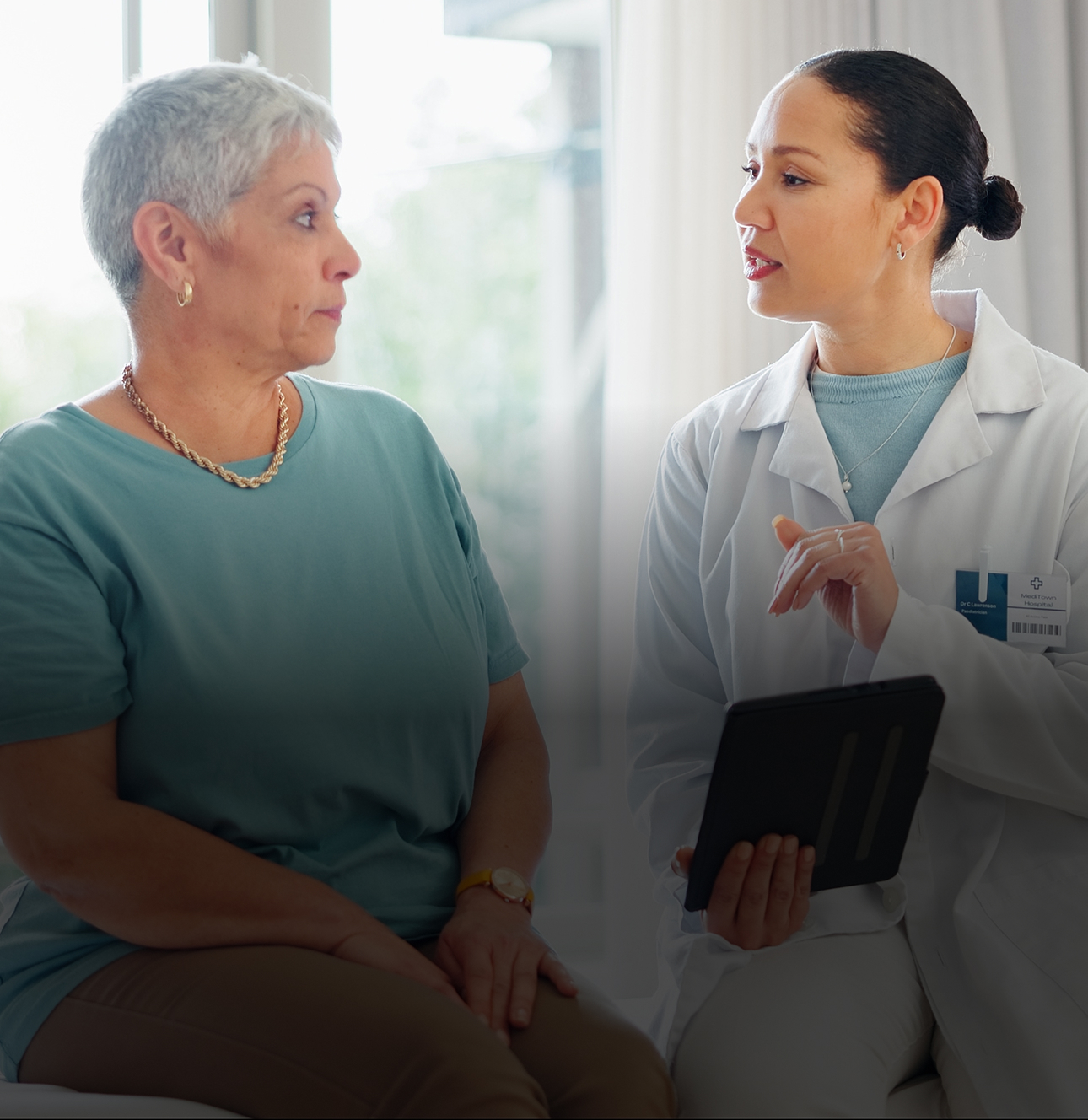 A senior woman having a conversation with her doctor.