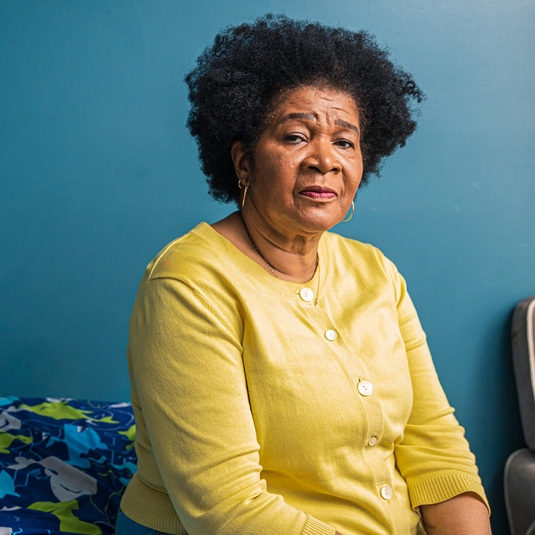 An African-American woman seen from the chest up with a serious expression
