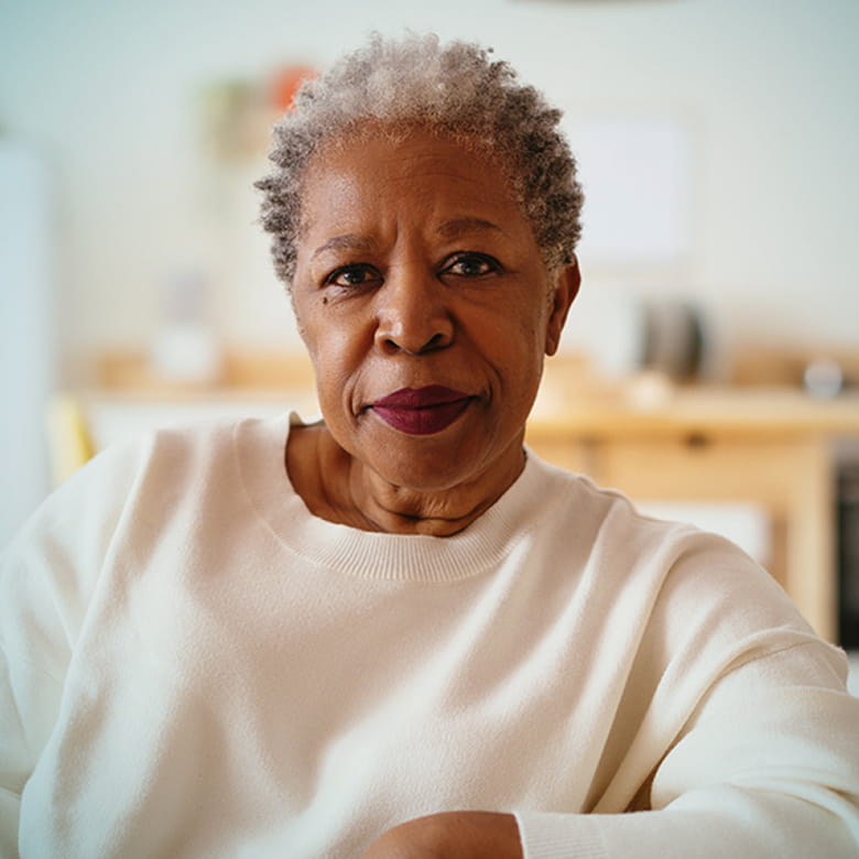 Actor portrayal of an older African-American woman facing the camera with a neutral expression.