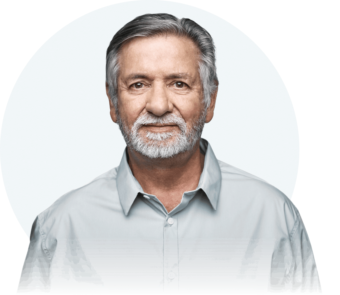 A white man with gray hair and a gray goatee is seen from the chest up. He is looking straight at the camera with a neutral expression.