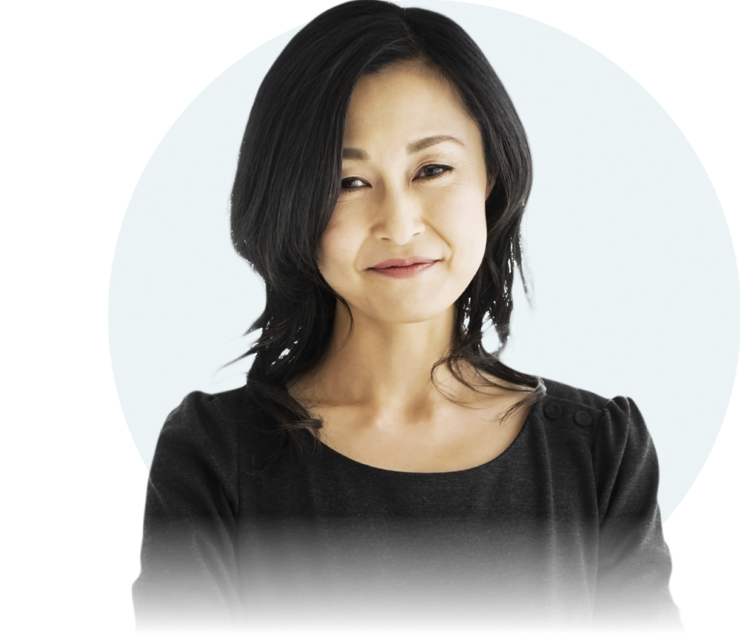An Asian woman with shoulder-length dark brown hair is seen from the chest up. She is looking straight at the camera and smiling.